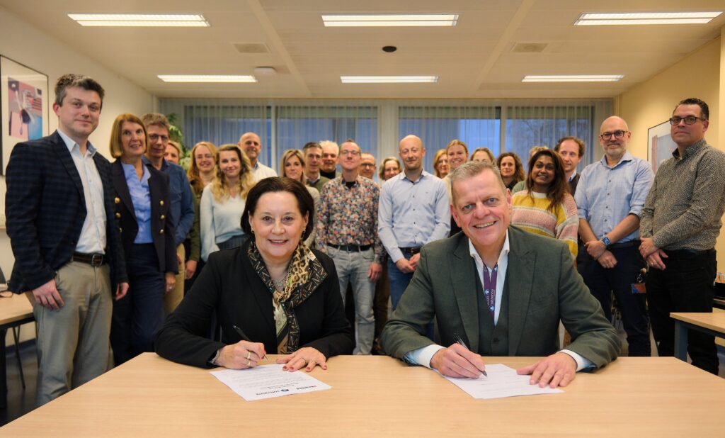 Bestuurvoorzitters Maria Jacobs van Maastro en Nardo van der Meer van het Catharina Ziekenhuis bekrachtigen de samenwerking met hun handtekening op papier. Foto: Jarno Verhoef/Catharina Ziekenhuis